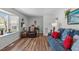View of the cozy living room with hardwood floors, bay window and comfortable furnishings at 1805 Holly St, Apex, NC 27502