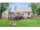 Spacious backyard with a deck, green lawn, and a cozy fire pit, perfect for outdoor gatherings at 1808 Betry Pl, Raleigh, NC 27603
