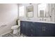 Modern bathroom with marble countertops, double vanity sinks, and black and white patterned tile flooring at 1808 Betry Pl, Raleigh, NC 27603