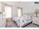 Comfortable bedroom with carpeted floors, dresser, matching nightstands, and soft curtains at 1808 Betry Pl, Raleigh, NC 27603