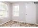 Inviting hallway featuring tiled floor, neutral paint, and natural light from multiple windows at 1808 Betry Pl, Raleigh, NC 27603
