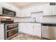 Modern kitchen showcasing stainless steel appliances, subway tile backsplash, and ample cabinetry at 1808 Betry Pl, Raleigh, NC 27603