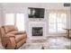 Inviting living area with fireplace, large windows, and comfortable seating arrangement at 1808 Betry Pl, Raleigh, NC 27603