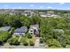 Aerial view of a neighborhood featuring a modern home surrounded by lush greenery and city buildings at 1820 Park Dr, Raleigh, NC 27605