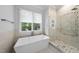 Bright bathroom featuring a soaking tub, walk-in shower, and window at 1820 Park Dr, Raleigh, NC 27605