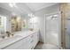 Bathroom with double vanity, bright mirrors, and access to shower at 1820 Park Dr, Raleigh, NC 27605