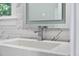 Bright bathroom featuring a white marble countertop, sleek faucet, and an illuminated mirror at 1820 Park Dr, Raleigh, NC 27605