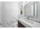 Stylish powder room boasts marble walls, a floating vanity, modern fixtures, and natural light at 1820 Park Dr, Raleigh, NC 27605