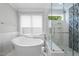 Luxurious bathroom with a freestanding tub, glass-enclosed shower, and marble accents at 1820 Park Dr, Raleigh, NC 27605