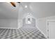 Large bonus room with patterned carpet, dormer window seat, and vaulted ceilings at 1820 Park Dr, Raleigh, NC 27605