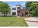Charming home featuring modern white siding, a wood accent, and a well-manicured lawn at 1820 Park Dr, Raleigh, NC 27605