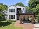Beautiful modern home boasts a stylish white and wood exterior and a red brick driveway at 1820 Park Dr, Raleigh, NC 27605