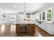 Open-concept kitchen with an island, white cabinetry, and a wine cooler for entertaining at 1820 Park Dr, Raleigh, NC 27605