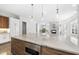 Open kitchen with an island featuring a marble countertop and modern stainless steel appliances at 1820 Park Dr, Raleigh, NC 27605