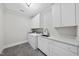 Bright laundry room with modern appliances, white cabinets, and ample counter space at 1820 Park Dr, Raleigh, NC 27605