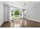 Bright living room features large windows, hardwood floors, and elegant chandelier at 1820 Park Dr, Raleigh, NC 27605
