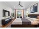 Tranquil main bedroom with sleek furniture, modern ceiling fan, and balcony access at 1820 Park Dr, Raleigh, NC 27605