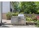 Outdoor kitchen with stone base and stainless grill nestled in a garden at 1820 Park Dr, Raleigh, NC 27605