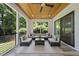 Covered porch with an outdoor living area, wood ceilings, and comfortable seating at 1820 Park Dr, Raleigh, NC 27605
