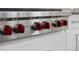 Close-up of a professional-grade stainless steel gas cooktop with red knobs at 1820 Park Dr, Raleigh, NC 27605