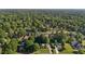 An aerial view showing the neighborhood and the home nestled among mature trees and manicured lawns at 2037 Gurney Ct, Burlington, NC 27215