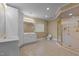 Bathroom featuring a double sink vanity, glass block window, and walk-in shower at 2037 Gurney Ct, Burlington, NC 27215