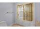 Bathroom with a shower-tub combo featuring gold-framed sliding glass doors and gold hardware at 2037 Gurney Ct, Burlington, NC 27215