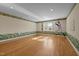 Spacious bedroom with hardwood floors, a window for natural light, and border art at 2037 Gurney Ct, Burlington, NC 27215