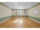Bright bedroom with hardwood floors, natural light from windows, and whimsical border art at 2037 Gurney Ct, Burlington, NC 27215