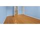 Bedroom with light blue walls, hardwood floors, white base trim and access to the hallway at 2037 Gurney Ct, Burlington, NC 27215