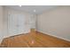 Neutral bedroom featuring hardwood floors, white trim, and three white doors at 2037 Gurney Ct, Burlington, NC 27215