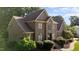 Stately brick home with manicured landscaping, mature trees, and a welcoming front entrance at 2037 Gurney Ct, Burlington, NC 27215