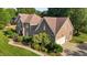 Expansive brick home with a lush green lawn, mature trees, and a multi-car garage at 2037 Gurney Ct, Burlington, NC 27215