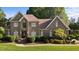 Charming two-story brick home with a manicured lawn and mature landscaping providing great curb appeal at 2037 Gurney Ct, Burlington, NC 27215