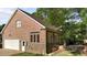 This home features brick facade, attached garage, and several large windows at 2037 Gurney Ct, Burlington, NC 27215