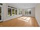 Bright living room with hardwood floors and a wall of windows overlooking the lush yard at 2037 Gurney Ct, Burlington, NC 27215