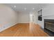 Open living room with hardwood floors, fireplace, and built-in shelving with view to other rooms at 2037 Gurney Ct, Burlington, NC 27215