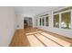Spacious living room with hardwood floors, large windows, and an open doorway to adjacent rooms at 2037 Gurney Ct, Burlington, NC 27215