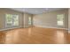Expansive living room featuring hardwood floors and multiple windows with views of the outdoors at 2037 Gurney Ct, Burlington, NC 27215