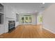 Spacious living room with hardwood floors, fireplace, built-in shelves, and french doors at 2037 Gurney Ct, Burlington, NC 27215