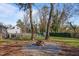 Inviting backyard with a fire pit, swing, patio seating, and mature trees for outdoor enjoyment at 205 Coachman Dr, Garner, NC 27529