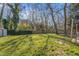 Lush backyard with mature trees, offering ample space for outdoor activities and relaxation at 205 Coachman Dr, Garner, NC 27529