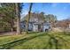 Landscaped backyard with patio and home view, perfect for outdoor relaxation and entertaining at 205 Coachman Dr, Garner, NC 27529