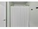 Bathroom featuring neutral paint, a tub and shower combo, and a simple design at 205 Coachman Dr, Garner, NC 27529