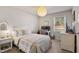 Cozy bedroom featuring wicker furniture, a desk, and a comfortable bed, perfect for relaxation at 205 Coachman Dr, Garner, NC 27529