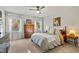Bright bedroom with two windows, wood furnishings, and a ceiling fan, offering a relaxing space at 205 Coachman Dr, Garner, NC 27529