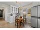 Bright dining area featuring a wooden table, chairs, a window, and white cabinets for storage at 205 Coachman Dr, Garner, NC 27529