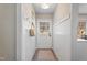 Inviting entryway featuring white wainscoting, coat hooks, and a view of the front door with a window at 205 Coachman Dr, Garner, NC 27529