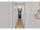 Hallway includes neutral walls, hardwood floors, and easy access to multiple rooms and storage space at 205 Coachman Dr, Garner, NC 27529