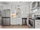 Updated kitchen with white cabinetry, subway tile backsplash, and stainless steel appliances at 205 Coachman Dr, Garner, NC 27529